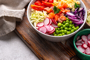Balanced healthy bowl with vegetables and salmon