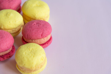 Colorful macarons arranged on a light background