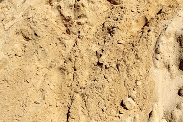 Texture of yellow sand lying on the surface.