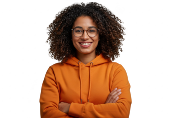 Smiling young woman with curly hair and glasses wearing an orange hoodie isolated on transparent background