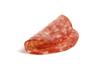 Round pieces of salami lie on a white background.