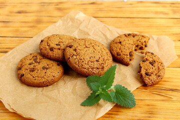 There are oatmeal cookies on the wooden table.