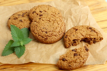 There are oatmeal cookies on the wooden table.