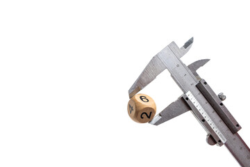 Caliper with wooden cube and dice, isolated on white background.