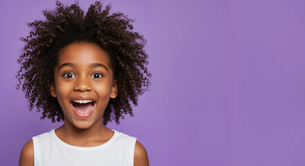 Excited African American girl with curly hair and open mouth against purple background. Pure childhood joy and amazement expressions. Children diversity and educational campaigns