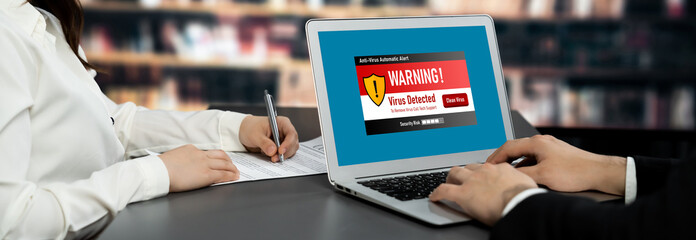 Virus warning alert on computer screen detected brisk cyber threat , hacker, computer virus and...