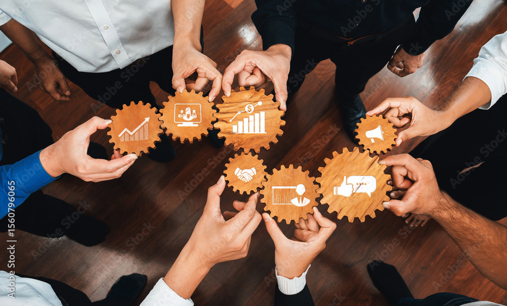 Aufkleber Capturing the essence of teamwork, this image shows diverse hands holding wooden gears representing business growth and collaboration in a dynamic professional setting. Amity