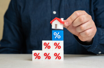 Man puts house on interest rate blocks. Mortgage flexibility, banking relief programs, loan...