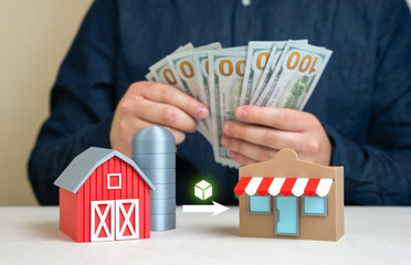 A man counts the profit from selling farm produce to stores. Transportation to the end consumer....