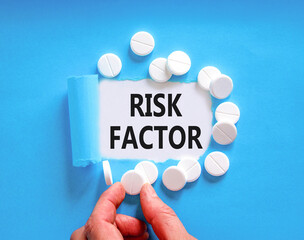 Risk factor symbol. Concept words Risk factor on beautiful white paper. White pills tablets....