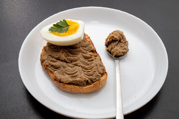 Fresh homemade veal liver pate, chicken pate on a white plate. Delicious homemade food. Options for a buffet.
