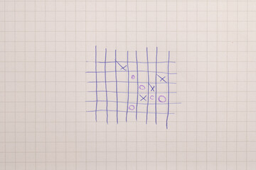 Hand-drawn tic-tac-toe game on graph paper
