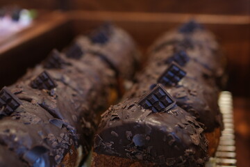 Chocolate Cromboloni or round puff pastry filled with cream, and glazed with chocolste topping....