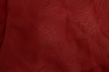 Close-up of red fabric texture with soft folds
