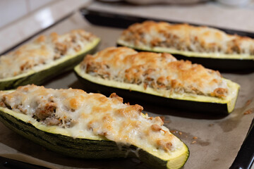 Closeup of baked zucchini stuffed with meat and rice
