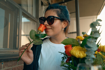 Woman smelling flowers in handmade pumpkin centerpiece