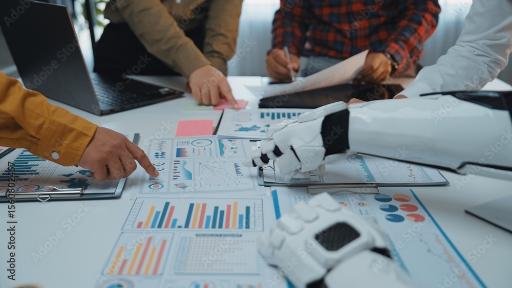 Poster a robot arm collaborates with team members during a business meeting, analyzing charts and graphs to