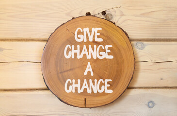 Give change a chance symbol. Concept words phrase Give change a chance on beautiful wooden circle....