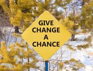Give change a chance symbol. Concept words phrase Give change a chance on beautiful yellow road sign. Beautiful winter forest background. Business Give change a chance concept. Copy space.