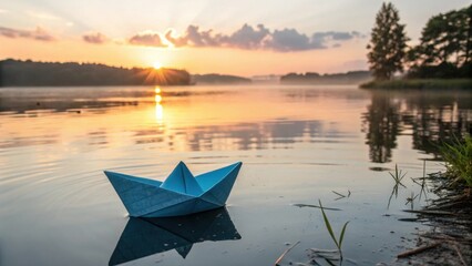 Blue Paper Boat Drifting Toward Sunrise Across Water
