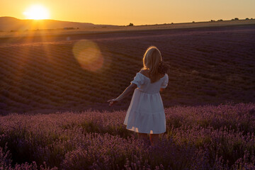 Lavender Woman Sunset: Tourist walks in field at sunset for photos on vacation in Provence.