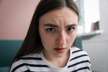 Scared woman suffering from paranoia at home