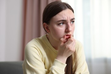 Scared woman suffering from paranoia at home
