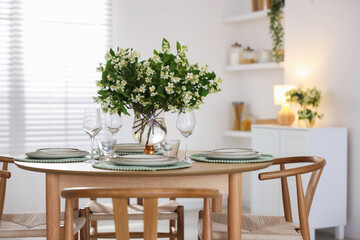 Bouquet of beautiful jasmine flowers on dining table indoors