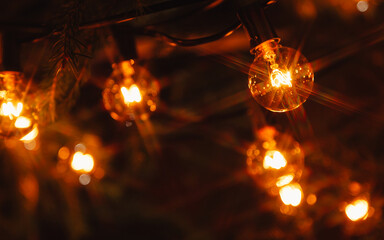 Background - electric garland with incandescent bulbs, yellow warm light