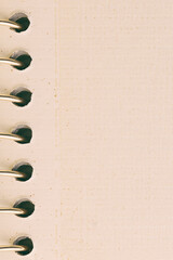 A close-up view of a spiral bound notebook showcasing its beige textured paper