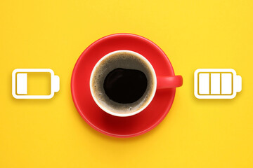 Cup of coffee and indicators on yellow background, top view. Low level battery becoming fully...