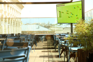 Broadcasting soccer match on TV set in bar