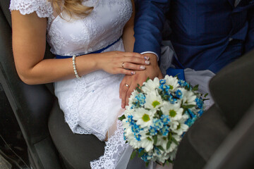 Bride and Groom Holding Hands with Bouquet