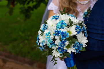 Bride Holding Blue and White Wedding Bouquet