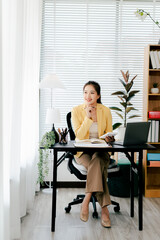 Young Asian woman doing financial accounting and taxes for a company Organizing account analysis...