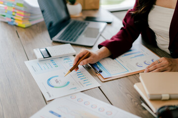 Young Asian woman doing financial accounting and taxes for a company Organizing account analysis reports Investment information Financial and tax system concepts