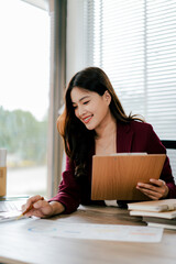 Young Asian woman doing financial accounting and taxes for a company Organizing account analysis...