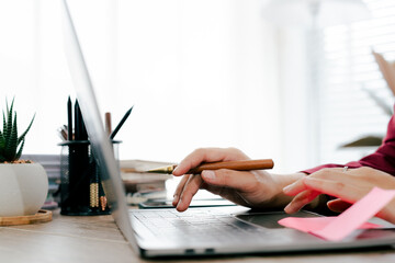 portrait typing keyboard on laptop computer. Working online on white table at office. Facebook chat. Website meeting. Blogger. Journalist writing articles. online job ideas