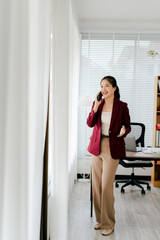 Asian businesswoman chatting on smartphone, auditor, document search, report, analysis, tax, accounting, document, data, contract, agreement at work.