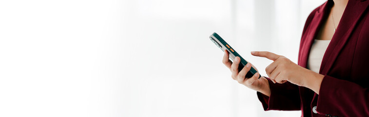 Portrait of young woman holding smartphone, typing text, chatting with friends on social network. Concept of using mobile application, online shopping, opening website, ordering food, business.