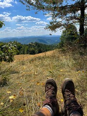 Resting Hiker with Boots Overlooking Mountain Landscape