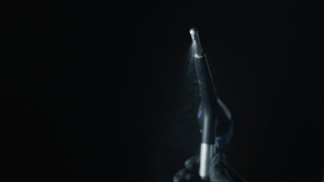 Dental Air abrasion with water spray, hydro abrasion or sandblasting teeth. High tech dental handpiece and water splash on dark background. dental hydro abrasion with water spray in slow motion video