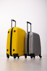 Woman with travel suitcase on light isolation background, concept of travel and vacation. Mockup