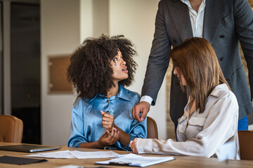 African american woman intern employee listens careful male boss