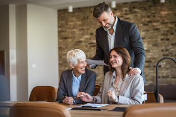 male and female executives explain new project to young female intern