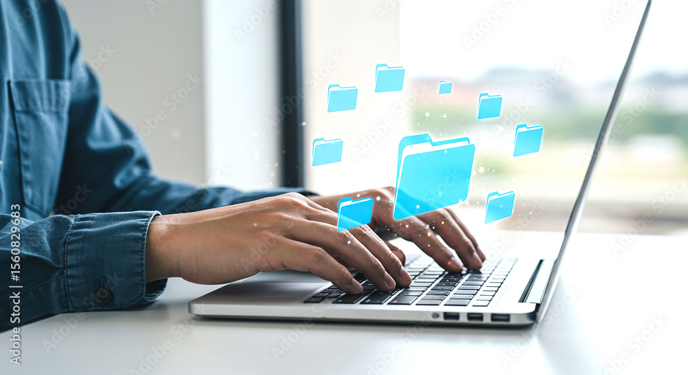 Poster person typing on laptop with blue folder icons floating above the keyboard on a white table top