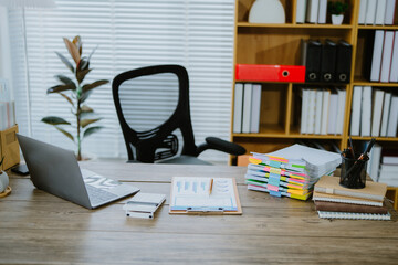 White office desk with digital tablet, a takeaway coffee cup, and stack of documents