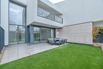 It provides a uniform green background that highlights patio furniture, plants, and structures.