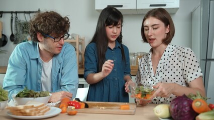 Happy father move to music while cooking food and prepare lunch at modern kitchen. Active dad...