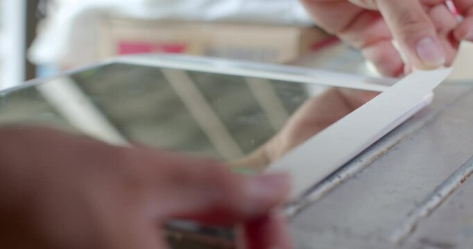 Applying masking tape in a straight line to guide clean adhesive application.Taping another edge with masking tape to prepare for glue application.
